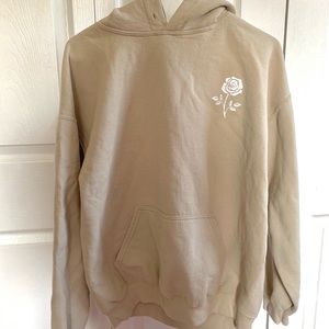 Cream colored sweatshirt with white rose